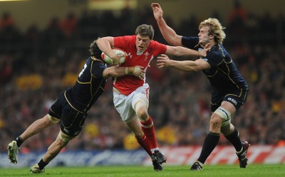 120212 - Wales v Scotland - RBS Six Nations 2012-Rhys Priestland of Wales is tackled by Ross Rennie and Richie Gray of Scotland