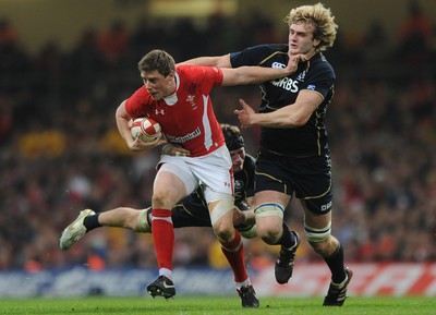 120212 - Wales v Scotland - RBS Six Nations 2012 -Rhys Priestland of Wales is tackled by Ross Rennie and Richie Gray of Scotland