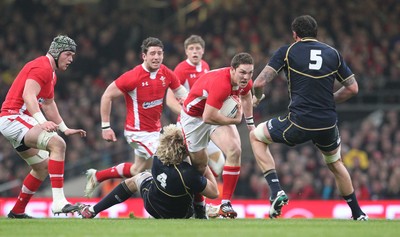 120212 - Wales v Scotland - RBS 6 Nations -Wales' George North is tackled by Scotland's Richie Gray and Scotland's Jim Hamilton