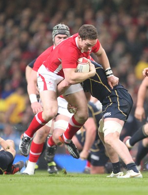 120212 - Wales v Scotland - RBS 6 Nations -Wales' George North is tackled by Scotland's Geoff Cross