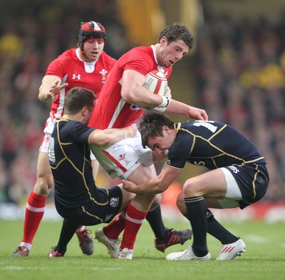 120212 - Wales v Scotland - RBS 6 Nations -Wales' Alex Cuthbert is tackled by Scotland's Greig Laidlaw and Lee Jones