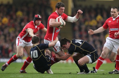 120212 - Wales v Scotland - RBS 6 Nations -Wales' Alex Cuthbert is tackled by Scotland's Greig Laidlaw and Lee Jones