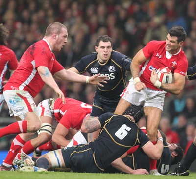 120212 - Wales v Scotland - RBS 6 Nations -Wales' Mike Phillips is tackled by Scotland's Alasdair Strokosch