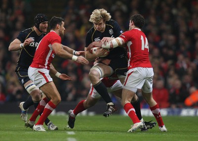 120212 - Wales v Scotland, RBS 6 Nations 2012 -Scotland's Richie Gray takes on Wales' Mike Phillips and Wales' Alex Cuthbert 