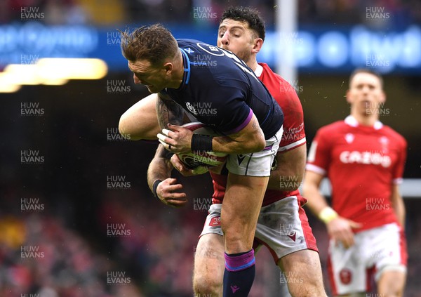 120222 - Wales v Scotland - Guinness Six Nations - Stuart Hogg of Scotland is tackled by Alex Cuthbert of Wales
