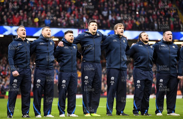 120222 - Wales v Scotland - Guinness Six Nations - Stuart Hogg, Finn Russell, Ali Price, Grant Gilchrist, Jonny Gray, Pierre Schoeman, Zander Fagerson of Scotland during the anthems