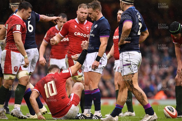 120222 - Wales v Scotland - Guinness Six Nations - Dan Biggar of Wales is helped by by Stuart Hogg of Scotland