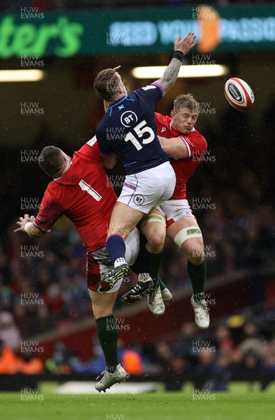 120222 - Wales v Scotland - Guinness Six Nations Championship - Stuart Hogg of Scotland goes uproar the ball with Wyn Jones and Jac Morgan of Wales