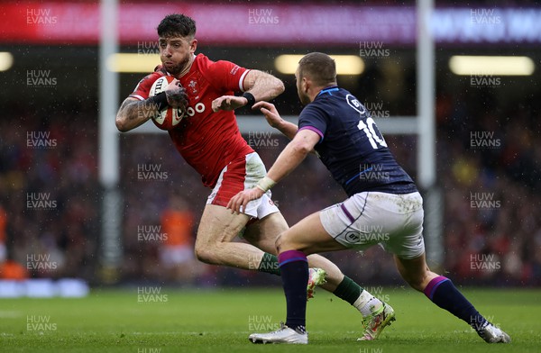 120222 - Wales v Scotland - Guinness Six Nations Championship - Alex Cuthbert of Wales is tackled by Finn Russell of Scotland