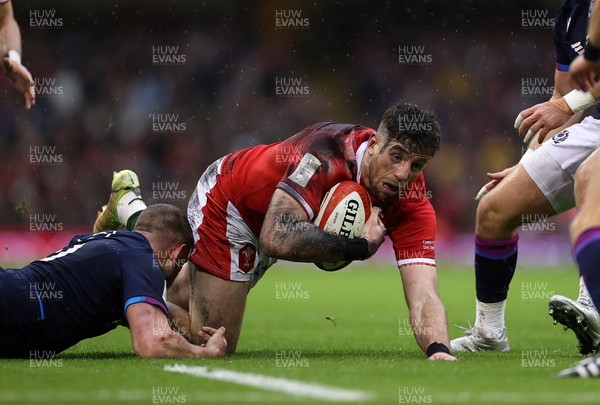 120222 - Wales v Scotland - Guinness Six Nations Championship - Alex Cuthbert of Wales is tackled by Finn Russell of Scotland