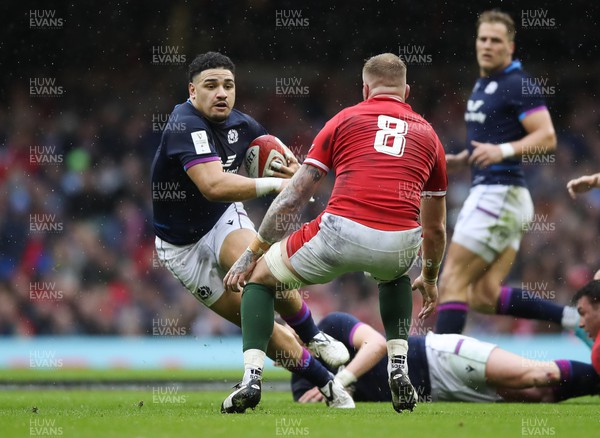 120222 - Wales v Scotland 2022 Guinness Six Nations - Sione Tuipulotu of Scotland takes on Ross Moriarty of Wales