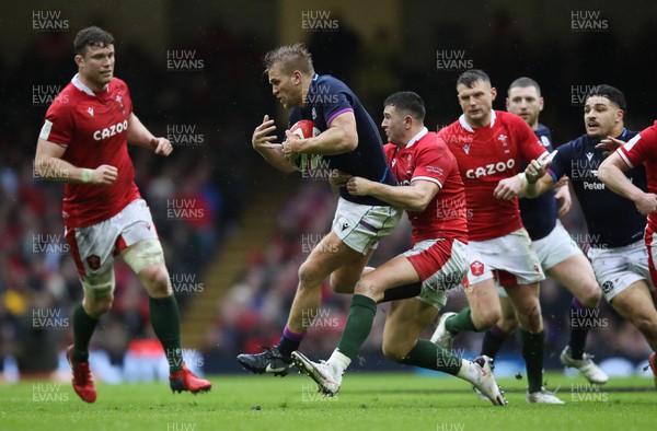 120222 - Wales v Scotland 2022 Guinness Six Nations - Chris Harris of Scotland is tackled by Owen Watkin of Wales