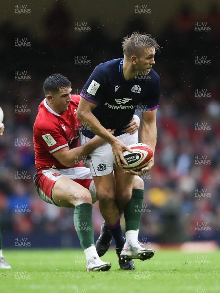 120222 - Wales v Scotland 2022 Guinness Six Nations - Chris Harris of Scotland is tackled by Owen Watkin of Wales