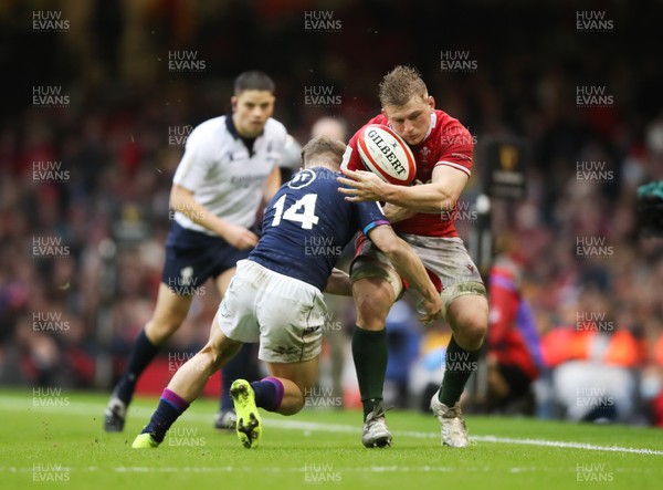 120222 - Wales v Scotland 2022 Guinness Six Nations - Jac Morgan of Wales is tackled by Darcy Graham of Scotland