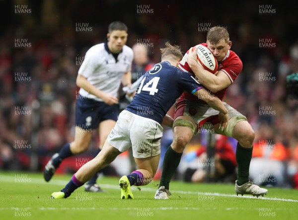 120222 - Wales v Scotland 2022 Guinness Six Nations - Jac Morgan of Wales is tackled by Darcy Graham of Scotland