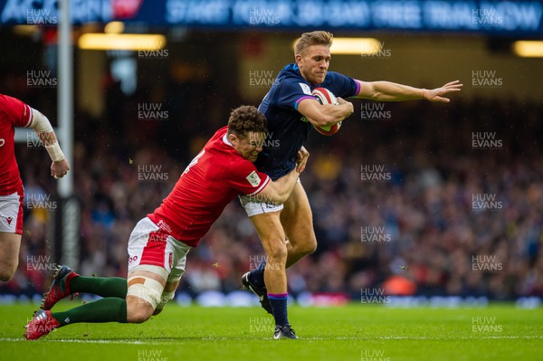 120222 - Wales v Scotland - Guinness Six Nations - Chris Harris of Scotland is tackled by Will Rowlands of Wales 
