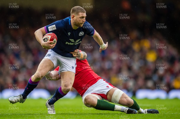 120222 - Wales v Scotland - Guinness Six Nations - Finn Russell of Scotland  evades the tackle of Ross Moriarty of Wales 