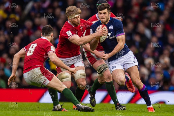 120222 - Wales v Scotland - Guinness Six Nations - Blair Kinghorn of Scotland is tackled by Aaron Wainwright of Wales 