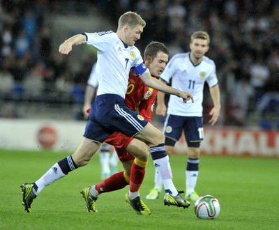 121012 - Wales v Scotland - FIFA 2014 World Cup Qualifying Campaign - Darren Fletcher of Scotland, front, competes with Aaron Ramsey of Wales for the ball 