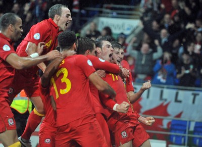 121012 - Wales v Scotland - FIFA 2014 World Cup Qualifying Campaign - Gareth Bale of Wales, second right, celebrates scoring the winner 