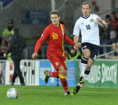 121012 - Wales v Scotland - FIFA 2014 World Cup Qualifying Campaign - Charlie Adam of Scotland, right, beats Aaron Ramsey of Wales to the ball 