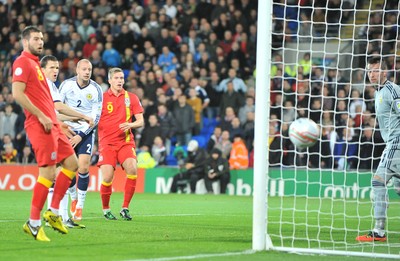 121012 - Wales v Scotland - FIFA 2014 World Cup Qualifying Campaign - Steve Morison of Wales, right, sees his header just miss the target and pass wide of the goal post 