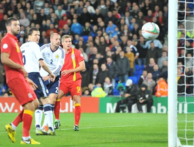 121012 - Wales v Scotland - FIFA 2014 World Cup Qualifying Campaign - Steve Morison of Wales, right, sees his header just miss the target and pass wide of the goal post 