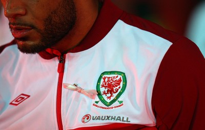 121012 - Wales v Scotland,  FIFA 2014 World Cup Qualifier -Welsh players take to the field wearing pink ribbons for missing five year old April Jones