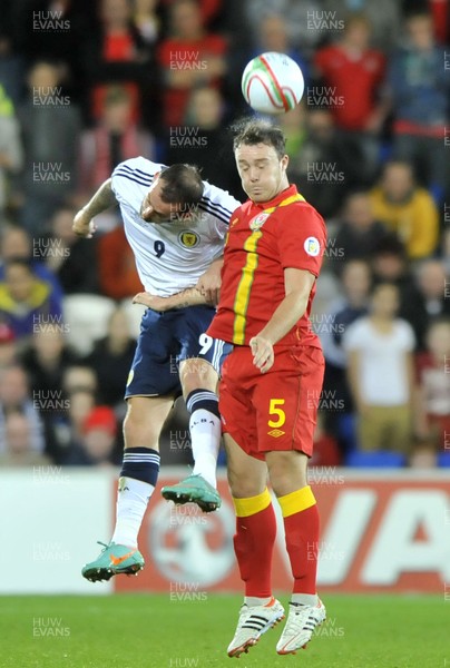 121012 - Wales v Scotland - FIFA 2014 World Cup Qualifying Campaign - Darcy Blake of Wales, right, beats Steven Fletcher of Scotland in the air  