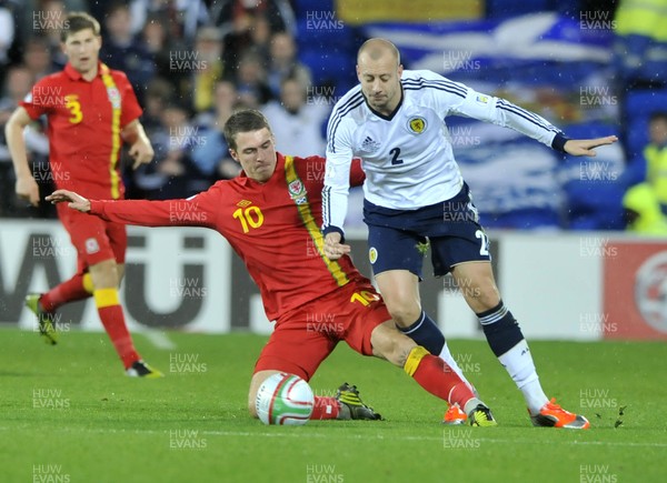 121012 - Wales v Scotland - FIFA 2014 World Cup Qualifying Campaign - Aaron Ramsey of Wales, left, tackles Alan Hutton of Scotland 