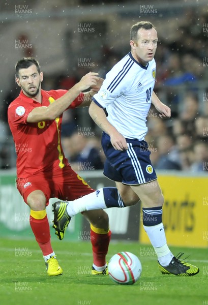 121012 - Wales v Scotland - FIFA 2014 World Cup Qualifying Campaign - Joe Ledley of Wales, left, closes down Charlie Adam of Scotland