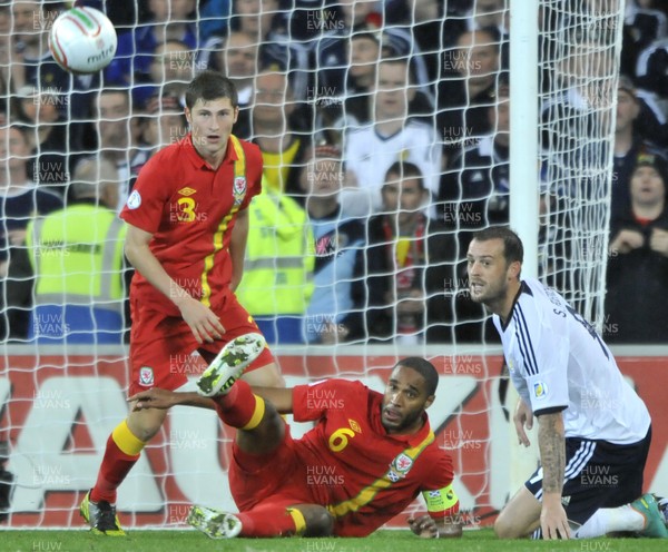 121012 - Wales v Scotland - FIFA 2014 World Cup Qualifying Campaign - Ashley WIlliams of Wales, middle, clears the ball from Steven Fletcher of Scotland 