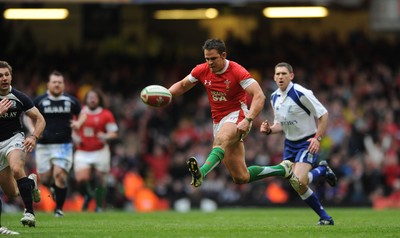 13.02.10 - Wales v Scotland - RBS Six Nations 2010 - Lee Byrne of Wales chips the ball ahead before being clashing with Phil Godman of Scotland. 
