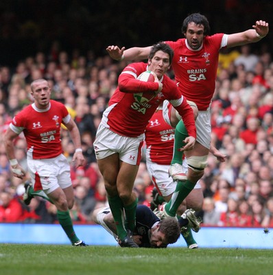 13.02.10 Wales v Scotland... James Hook with Jonathan Thomas in support  is tackled by  Scotland's Chris Cusiter. .