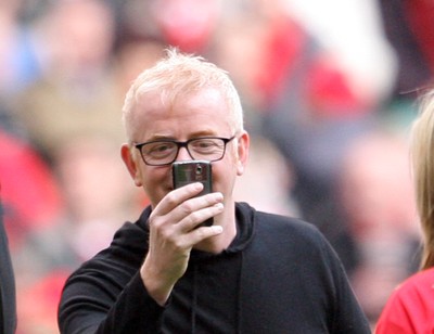 13.02.10 Wales v Scotland... Radio 2 DJ Chris Evans takes pictures with his phone while on the pitch of the Millennium Stadium during half time. 