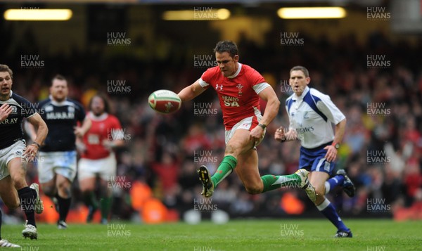 13.02.10 - Wales v Scotland - RBS Six Nations 2010 - Lee Byrne of Wales chips the ball ahead before being clashing with Phil Godman of Scotland. 