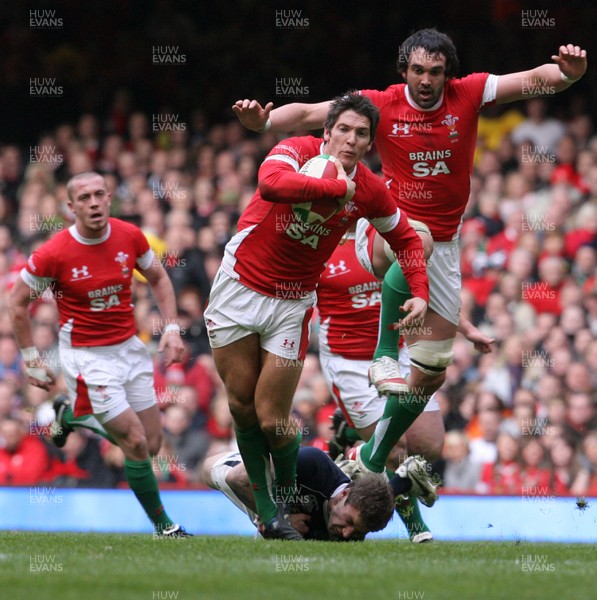 13.02.10 Wales v Scotland... James Hook with Jonathan Thomas in support  is tackled by  Scotland's Chris Cusiter. .
