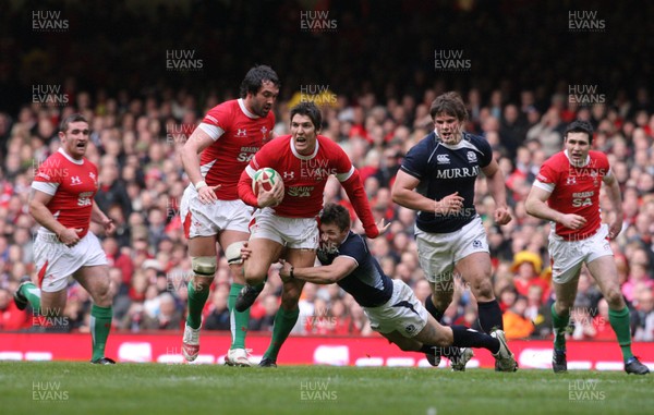 13.02.10 Wales v Scotland... James Hook is tackled by  Scotland's Chris Cusiter. .