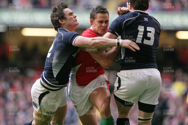 13.02.10 Wales v Scotland... Wales' Lee Byrne  is tackled by Scotland's Max Evans and Scotland's Sean Lamont. 
