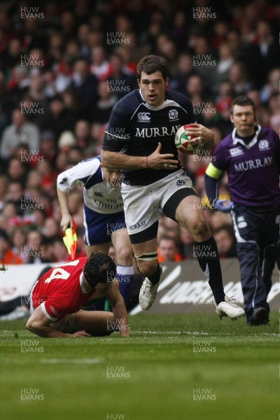 13.02.10 Wales v Scotland - RBS 6 Nations -  Scotland's Sean Lamont skips through the tackle of Wales' Leigh Halfpenny. 