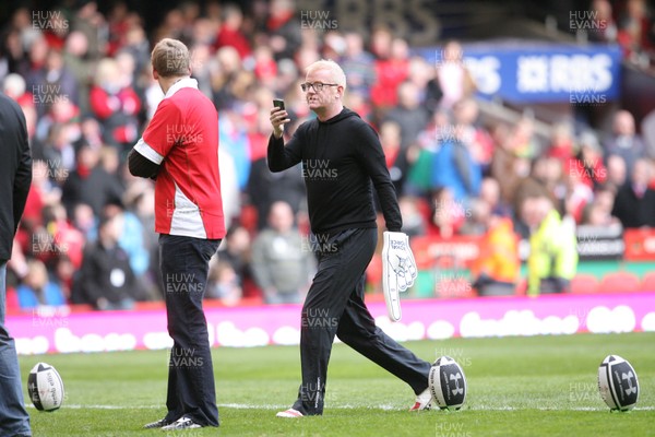 13.02.10 Wales v Scotland... Radio 2 DJ Chris Evans uses his phone to take pictures while on the pitch of the Millennium Stadium during half time. .