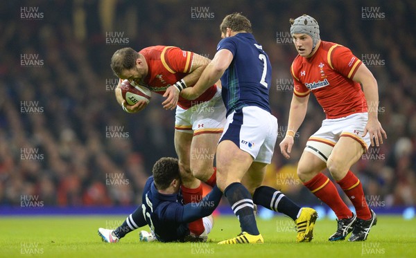 130216 - Wales v Scotland - RBS 6 Nations 2016 -Jamie Roberts of Wales is tackled by Duncan Taylor and Ross Ford of Scotland