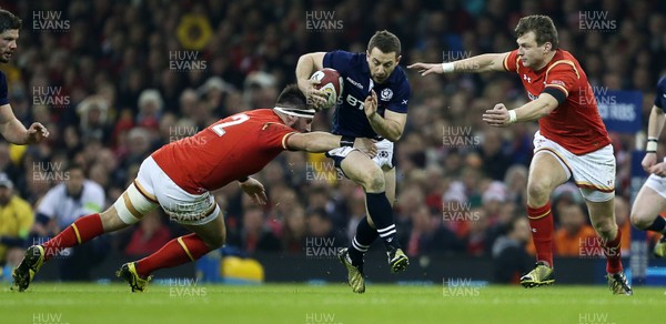 130216 - Wales v Scotland - RBS 6 Nations 2016 - Greig Laidlaw of Scotland is tackled by Rob Evans and Dan Biggar of Wales