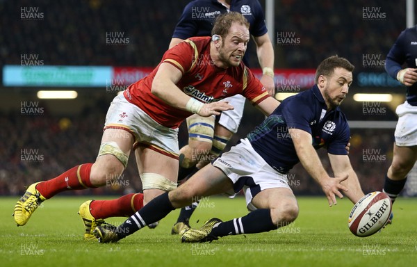 130216 - Wales v Scotland - RBS 6 Nations 2016 - Greig Laidlaw of Scotland is hounded by Alun Wyn Jones of Wales for the ball