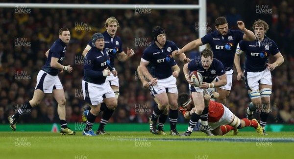 130216 - Wales v Scotland - RBS 6 Nations 2016 - Stuart Hogg of Scotland is tackled by Scott Baldwin of Wales