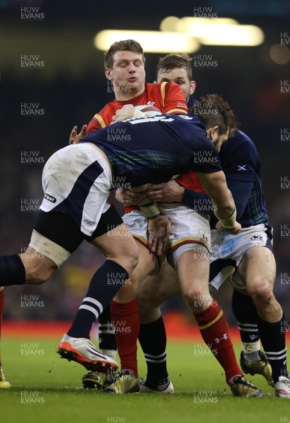 130216 - Wales v Scotland, RBS 6 Nations 2016 - Dan Biggar of Wales is wrapped up by the Scottish defence