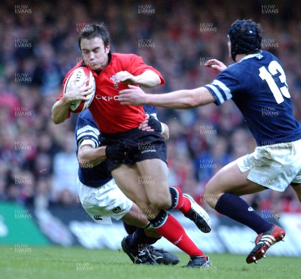 14.02.04  Wales v Scotland  Rhys Williams feels the force of a Staurt Grimes tackle.  Huw Evans,Cardiff