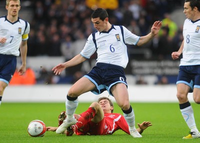 14.11.09 - International Football Friendly, Wales v Scotland Scotland's Graham  Dorrans is tackled by Wales' Aaron Ramsey 