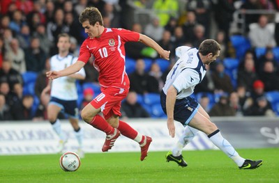 14.11.09 - International Football Friendly, Wales v Scotland Wales' Aaron Ramsey gets past Scotland's Stephen McManus on his way to score his sides third goal 