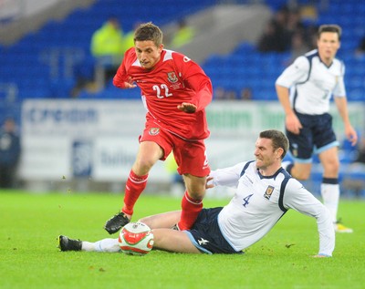 14.11.09 - International Football Friendly, Wales v Scotland Wales' Joe Allen is tackled by Scotland's Stephen McManus 